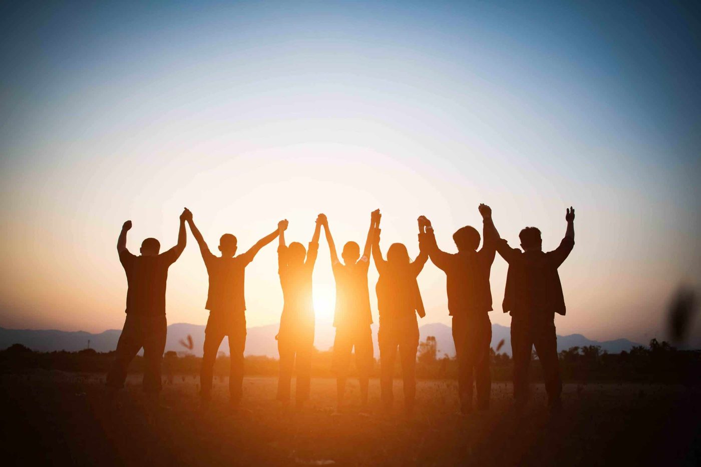 A team celebrating together at sunset